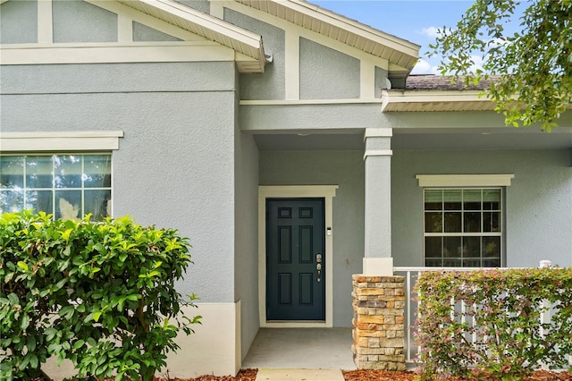2125 Shackley Pl, Apopka, FL 32703 - view of exterior entry with stucco siding and a porch
