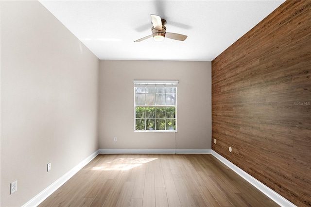2125 Shackley Pl, Apopka, FL 32703 - spare room with wood walls, a ceiling fan, wood finished floors, and an accent wall