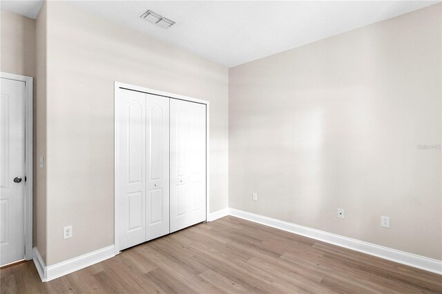 2125 Shackley Pl, Apopka, FL 32703 - unfurnished bedroom with light wood-type flooring and a closet