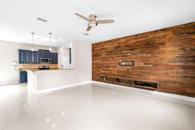 2125 Shackley Pl, Apopka, FL 32703 - unfurnished living room with ceiling fan, wood walls, light tile patterned floors, and recessed lighting