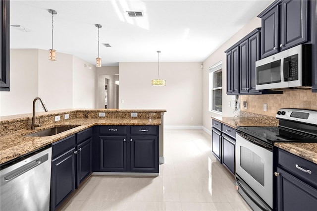 2125 Shackley Pl, Apopka, FL 32703 - kitchen with appliances with stainless steel finishes, decorative backsplash, hanging light fixtures, stone countertops, and light tile patterned floors