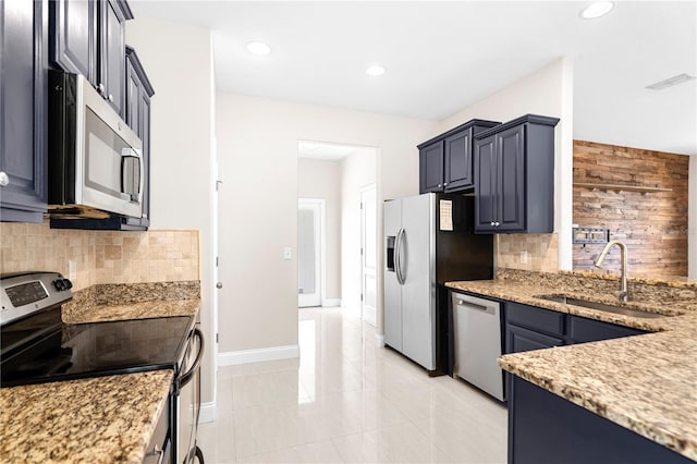 2125 Shackley Pl, Apopka, FL 32703 - kitchen featuring appliances with stainless steel finishes, backsplash, light stone counters, and recessed lighting