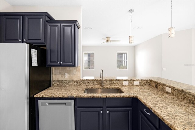 2125 Shackley Pl, Apopka, FL 32703 - kitchen with stainless steel appliances, ceiling fan, pendant lighting, backsplash, and light stone countertops