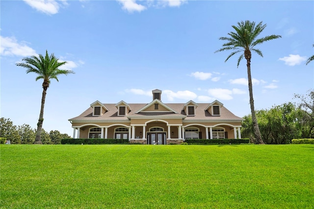 2125 Shackley Pl, Apopka, FL 32703 - view of front of house with a front lawn, french doors, covered porch, stucco siding, and stone siding