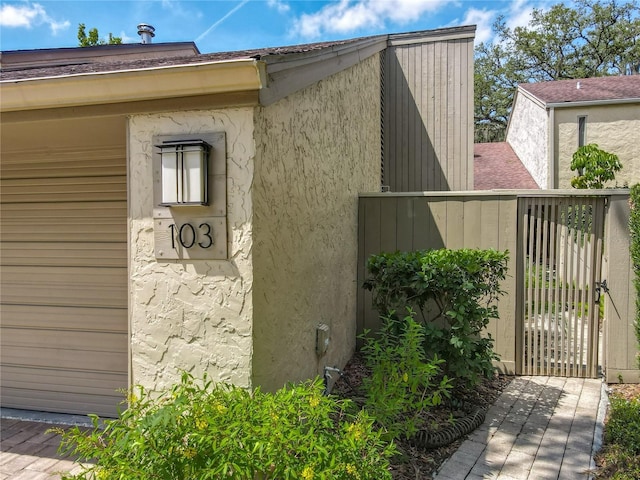103 Red Cedar Dr, Longwood, FL 32779 - view of side of property with stucco siding and a gate
