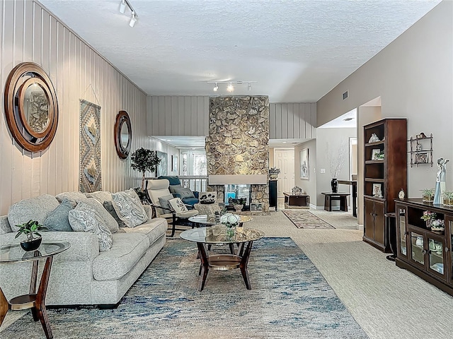 103 Red Cedar Dr, Longwood, FL 32779 - living area with track lighting, a textured ceiling, carpet flooring, and wood walls