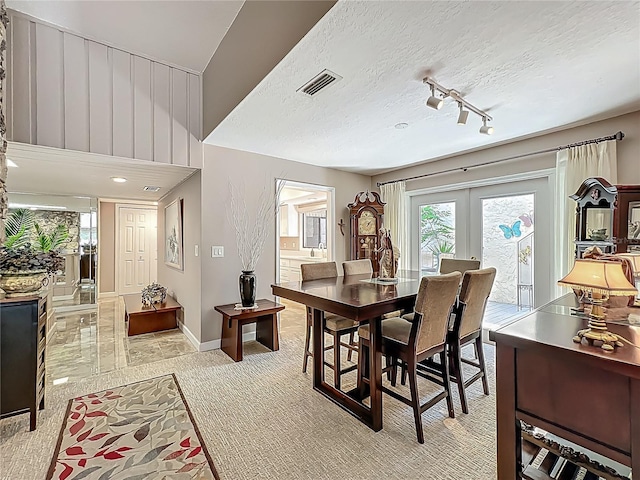 103 Red Cedar Dr, Longwood, FL 32779 - dining space featuring french doors, light carpet, baseboards, a textured ceiling, and track lighting