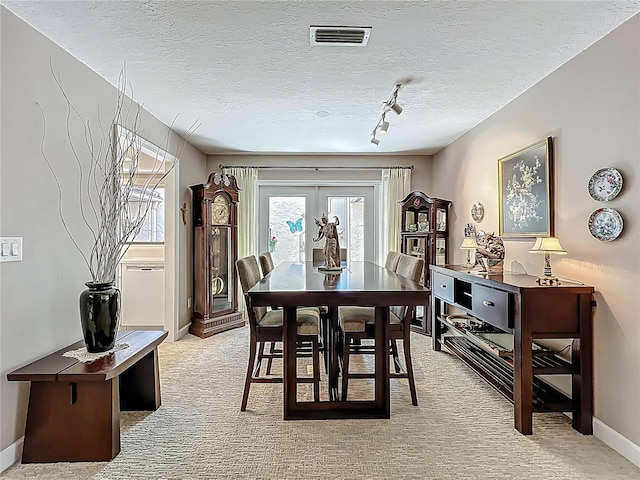 103 Red Cedar Dr, Longwood, FL 32779 - dining room with light carpet, rail lighting, baseboards, and a textured ceiling
