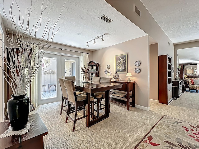 103 Red Cedar Dr, Longwood, FL 32779 - dining room featuring light carpet, a textured ceiling, rail lighting, french doors, and baseboards