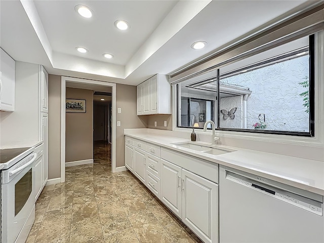 103 Red Cedar Dr, Longwood, FL 32779 - kitchen with dishwashing machine, electric range, a sink, baseboards, and white cabinets