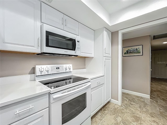 103 Red Cedar Dr, Longwood, FL 32779 - kitchen with white appliances, light countertops, white cabinets, and baseboards