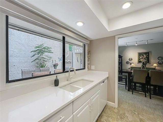 103 Red Cedar Dr, Longwood, FL 32779 - kitchen featuring a sink, white dishwasher, white cabinets, light countertops, and baseboards