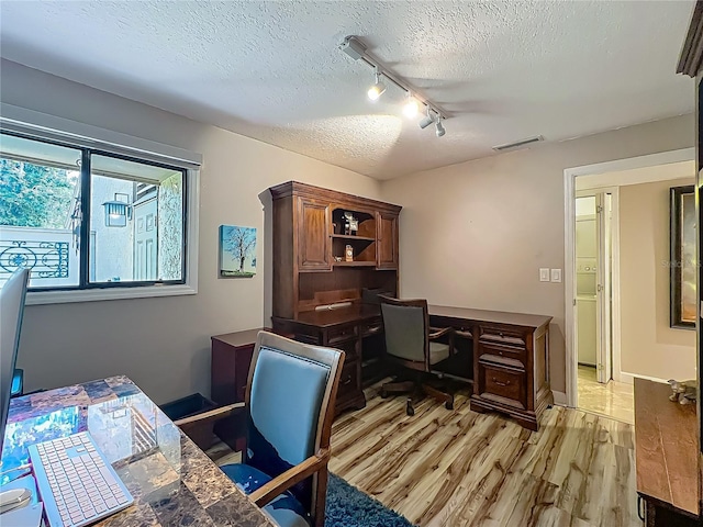 103 Red Cedar Dr, Longwood, FL 32779 - office space featuring track lighting, a textured ceiling, and light wood-type flooring
