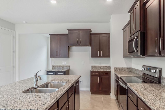 3975 Kennebunk Loop, Mount Dora, FL 32757 - kitchen featuring stainless steel appliances, a sink, light stone counters, and dark brown cabinetry