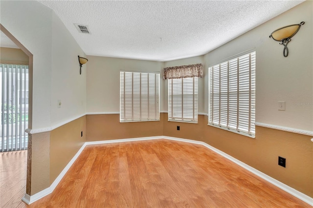 935 Northern Dancer Way Unit 107, Casselberry, FL 32707 - spare room featuring wood finished floors, a textured ceiling, and baseboards