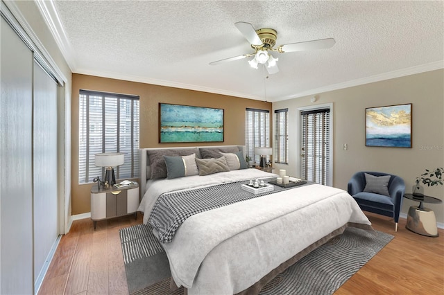 935 Northern Dancer Way Unit 107, Casselberry, FL 32707 - bedroom featuring wood finished floors, baseboards, a textured ceiling, multiple windows, and ornamental molding