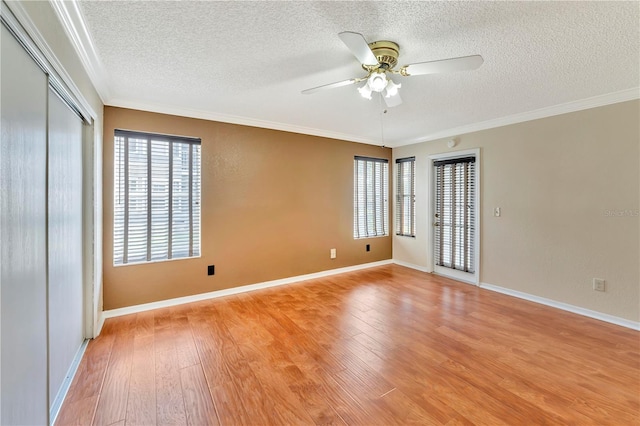 935 Northern Dancer Way Unit 107, Casselberry, FL 32707 - empty room featuring a textured ceiling, wood finished floors, a ceiling fan, ornamental molding, and baseboards