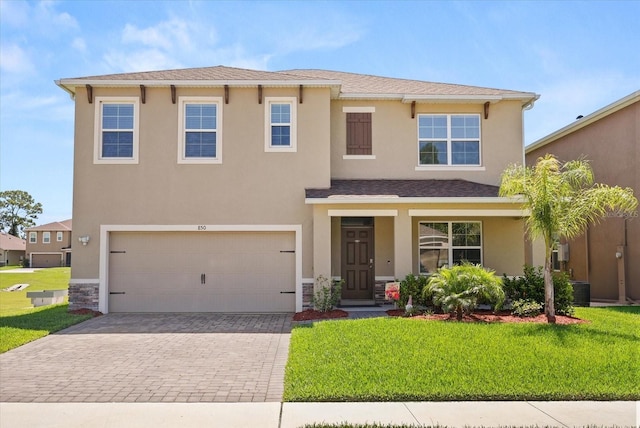 850 Lazio Cir, Debary, FL 32713 - view of front facade featuring driveway, a front lawn, stucco siding, and a garage