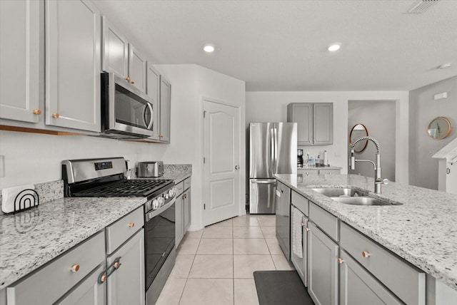 850 Lazio Cir, Debary, FL 32713 - kitchen featuring stainless steel appliances, a sink, gray cabinets, light tile patterned flooring, and light stone counters