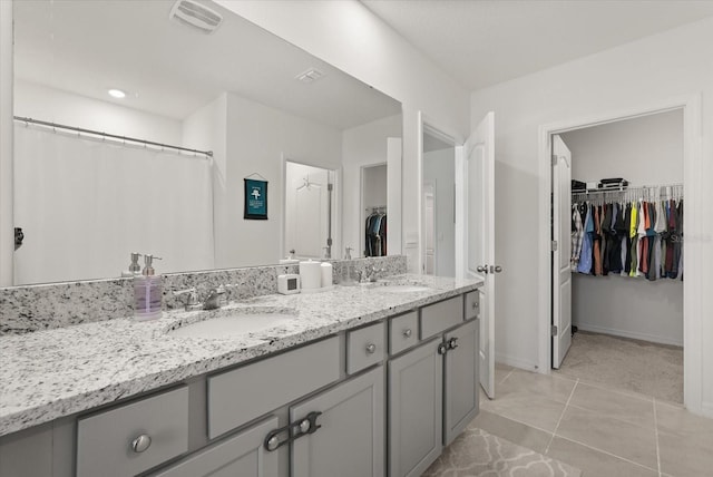 850 Lazio Cir, Debary, FL 32713 - full bath featuring double vanity, a walk in closet, tile patterned flooring, and baseboards