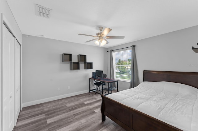 1902 Hailsham Ct, Orlando, FL 32824 - bedroom featuring wood finished floors, a closet, baseboards, a ceiling fan, and an office area