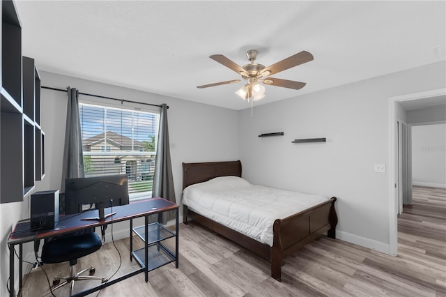 1902 Hailsham Ct, Orlando, FL 32824 - bedroom featuring wood finished floors, baseboards, ceiling fan, and a desk