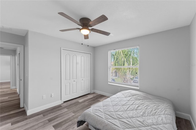 1902 Hailsham Ct, Orlando, FL 32824 - bedroom with a closet, wood finished floors, baseboards, and ceiling fan