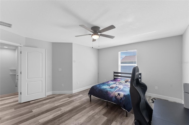 1902 Hailsham Ct, Orlando, FL 32824 - bedroom featuring wood finished floors, ceiling fan, baseboards, and a desk