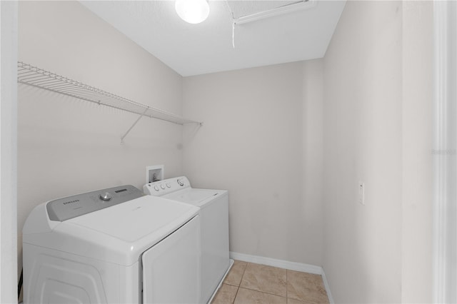 1902 Hailsham Ct, Orlando, FL 32824 - laundry room with washing machine and clothes dryer, light tile patterned flooring, and baseboards