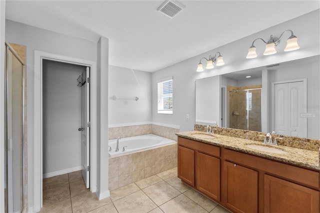 1902 Hailsham Ct, Orlando, FL 32824 - full bath with tile patterned flooring, a shower stall, a garden tub, and double vanity