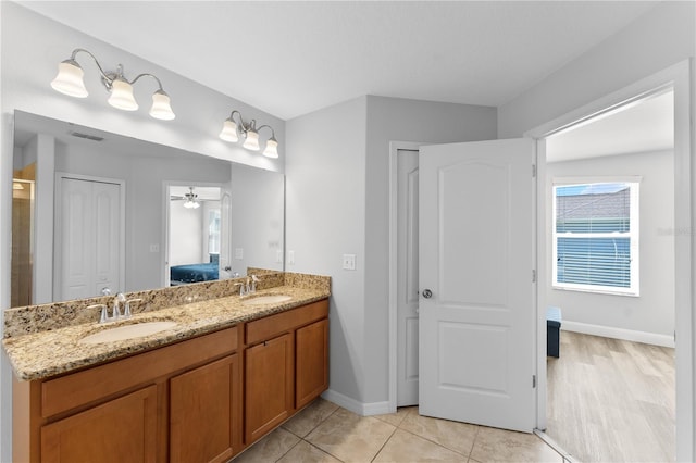 1902 Hailsham Ct, Orlando, FL 32824 - bathroom featuring connected bathroom, double vanity, a ceiling fan, baseboards, and tile patterned floors