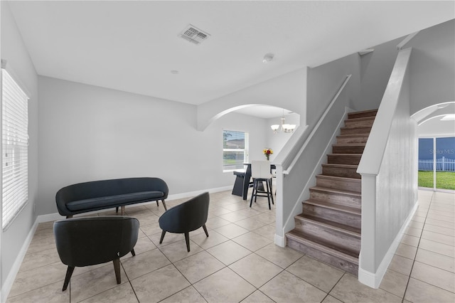 1902 Hailsham Ct, Orlando, FL 32824 - stairs with arched walkways, tile patterned flooring, baseboards, and a chandelier