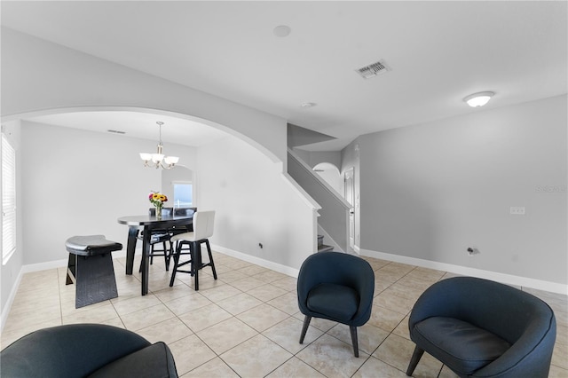 1902 Hailsham Ct, Orlando, FL 32824 - living area with arched walkways, stairway, light tile patterned floors, and a chandelier