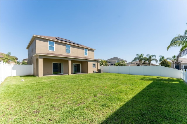 1902 Hailsham Ct, Orlando, FL 32824 - rear view of house with solar panels, cooling unit, and stucco siding