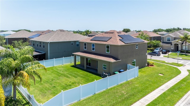 1902 Hailsham Ct, Orlando, FL 32824 - view of front facade with a residential view, solar panels, stucco siding, and a shingled roof