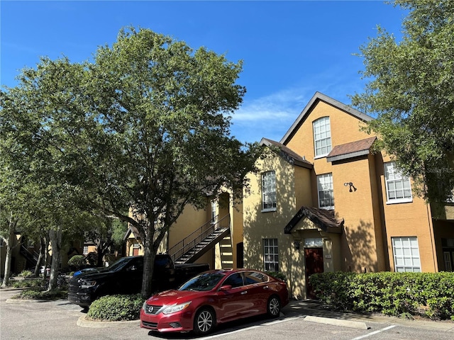 view of front of property with uncovered parking and stucco siding