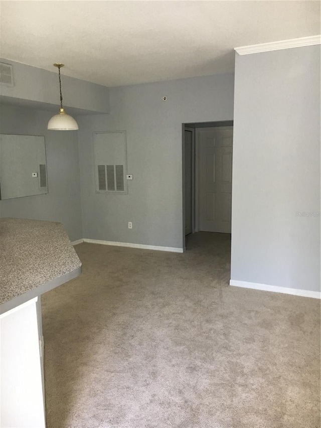 unfurnished living room featuring carpet floors and baseboards