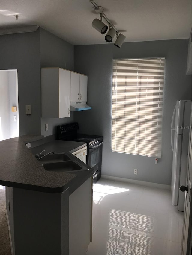 kitchen with freestanding refrigerator, electric range, under cabinet range hood, a peninsula, and white cabinets