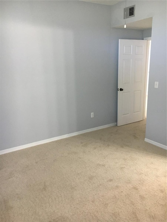 unfurnished room with carpet floors and baseboards