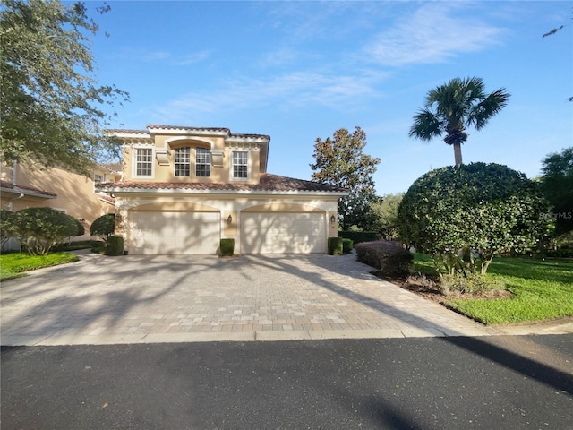 84 Camino Real Blvd, Howey In The Hills, FL 34737 - mediterranean / spanish home featuring decorative driveway, a tile roof, stucco siding, and an attached garage