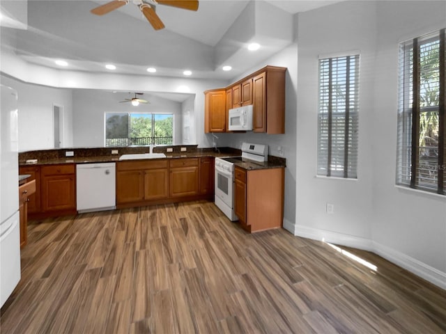 84 Camino Real Blvd, Howey In The Hills, FL 34737 - kitchen with white appliances, a ceiling fan, brown cabinets, a sink, and lofted ceiling
