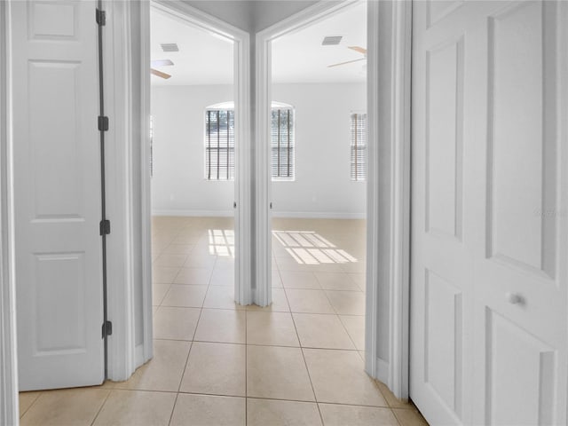 84 Camino Real Blvd, Howey In The Hills, FL 34737 - corridor featuring light tile patterned flooring, plenty of natural light, and baseboards