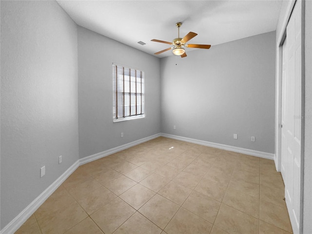 84 Camino Real Blvd, Howey In The Hills, FL 34737 - unfurnished bedroom featuring light tile patterned floors, a closet, baseboards, and a ceiling fan