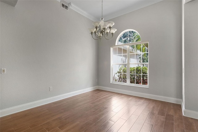 7900 Saint Giles Pl, Orlando, FL 32835 - empty room with a chandelier, baseboards, ornamental molding, and dark wood-style flooring
