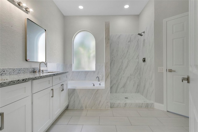 7900 Saint Giles Pl, Orlando, FL 32835 - bathroom with a garden tub, a marble finish shower, vanity, tile patterned floors, and recessed lighting