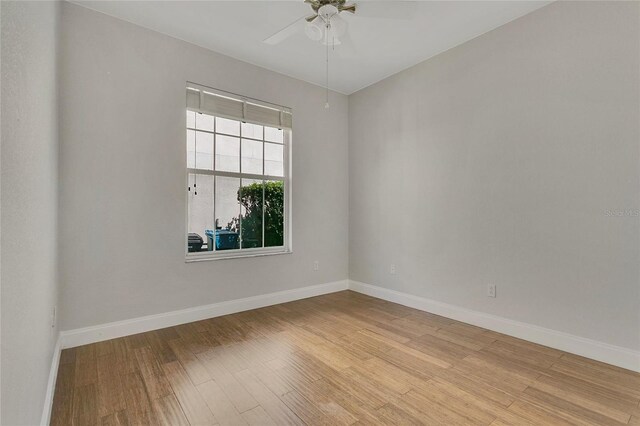 7900 Saint Giles Pl, Orlando, FL 32835 - empty room with light wood-style flooring, ceiling fan, and baseboards