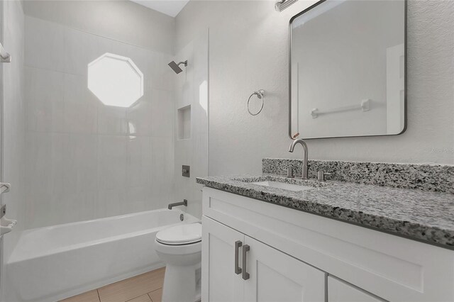 7900 Saint Giles Pl, Orlando, FL 32835 - bathroom featuring toilet, tub / shower combination, vanity, wood finished floors, and a textured wall