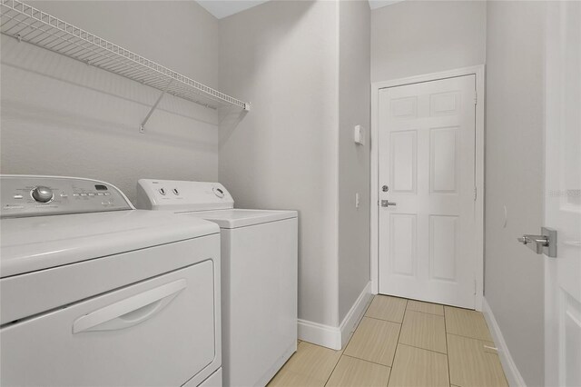 7900 Saint Giles Pl, Orlando, FL 32835 - washroom featuring washing machine and dryer and baseboards