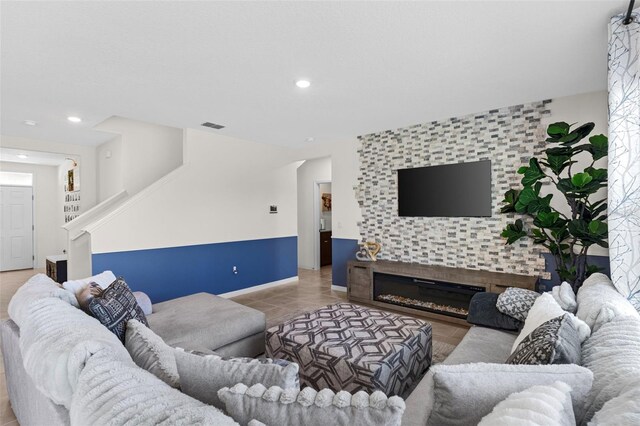 616 Griffon Ave, Lake Alfred, FL 33850 - living area with stairway, light tile patterned flooring, an accent wall, baseboards, and recessed lighting