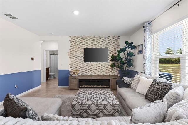 616 Griffon Ave, Lake Alfred, FL 33850 - living room featuring tile patterned flooring, baseboards, and a tile fireplace